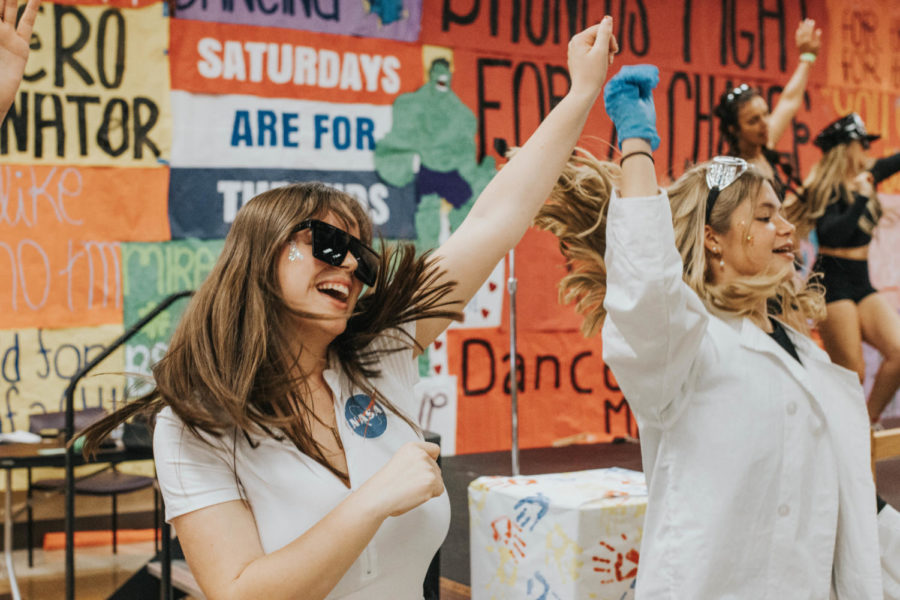 Rylie Manning and Hailey Garcia throw their hands in the air and wave them for the kids.