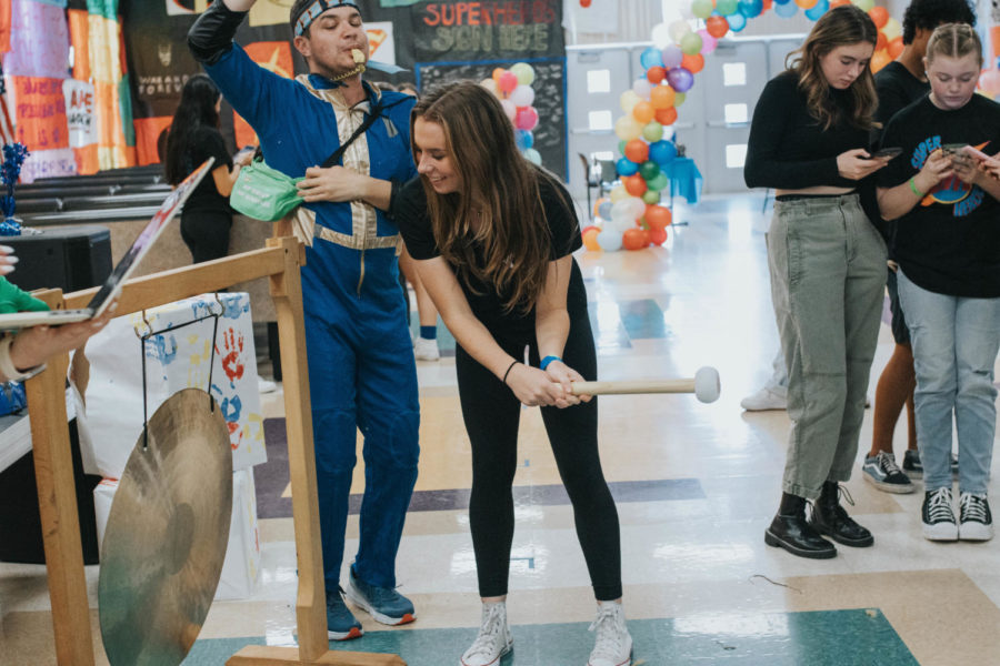 Charlotte Bullen gets to bang the gong for raising money to help  UF's Shand's Hospital part of the Children's Miracle Network.